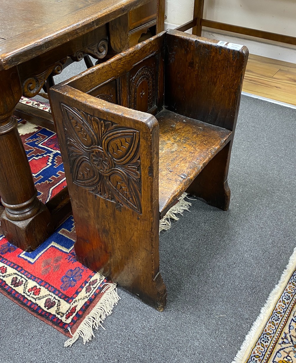 A small 17th century style oak hall seat, width 53cm, depth 29cm, height 66cm